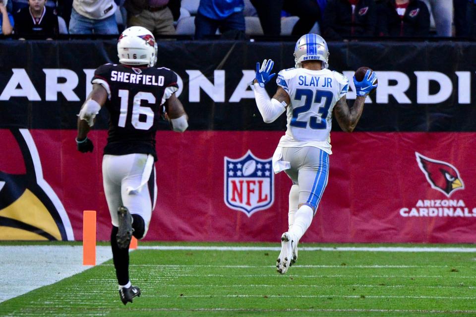 Detroit Lions cornerback Darius Slay returns an interception for a touchdown as Arizona Cardinals receiver Trent Sherfield watches during the second half at State Farm Stadium, Dec. 9, 2018.