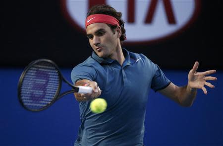 Roger Federer of Switzerland hits a return to Rafael Nadal of Spain during their men's singles semi-final match at the Australian Open 2014 tennis tournament in Melbourne January 24, 2014. REUTERS/Jason Reed