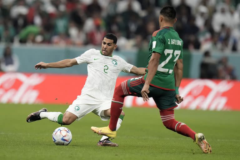 Saudi Arabia's Sultan Al-Ghanam, left, and Mexico's Jesus Gallardo chall;enge for the ball during the World Cup group C soccer match between Saudi Arabia and Mexico, at the Lusail Stadium in Lusail, Qatar, Wednesday, Nov. 30, 2022. (AP Photo/Moises Castillo)