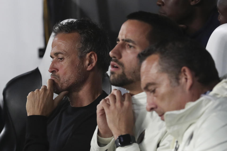 PSG's head coach Luis Enrique, left, sits on the bench before the start of the Champions League group F soccer match between Newcastle and Paris Saint Germain at St. James' Park, Wednesday, Oct. 4, 2023, in Newcastle, England. (AP Photo/Scott Heppell)