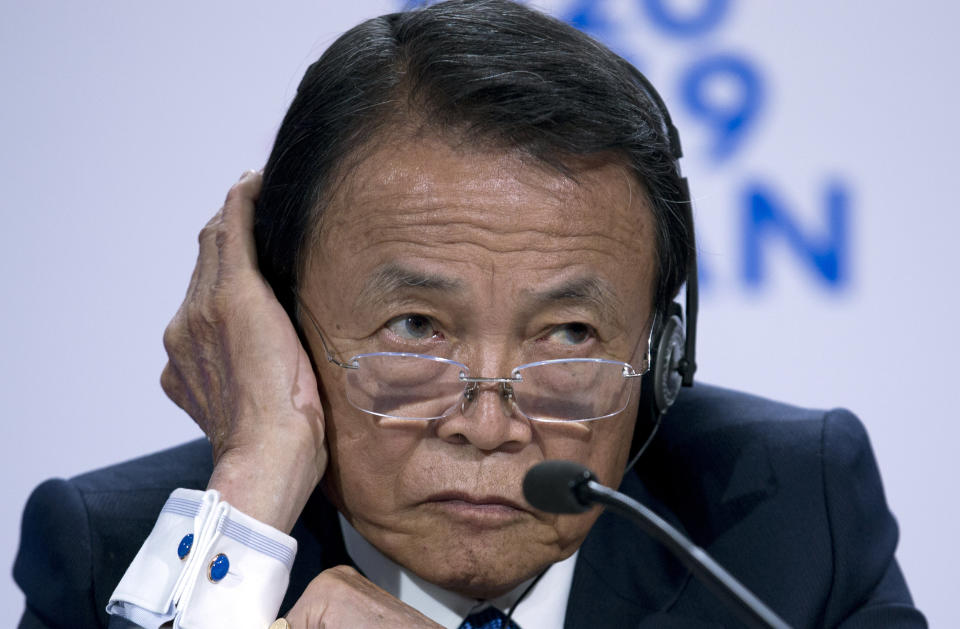 Japan's Finance Minister Taro Aso listens during a news conference in the sidelines of the World Bank/IMF Annual Meetings in Washington, Friday, Oct. 18, 2019. (AP Photo/Jose Luis Magana)