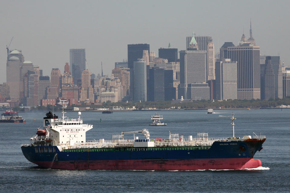 FILE - In this Aug. 27, 2008 file photo, an oil tanker makes its way through New York Harbor past the Manhattan skyline. The vast majority of economists surveyed this month by The Associated Press say lifting restrictions on exports of oil and natural gas would help the economy even if it meant higher fuel prices for consumers.. (AP Photo/Mark Lennihan, File)