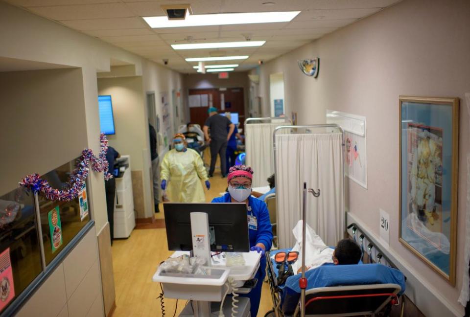 A healthcare worker talks to a patient in the ER at Oakbend Medical Center in Richmond, Texas, on July 15, 2020. - The latest modeling projects the number of COVID-19 deaths in the US to increase further, even as one research team suggests the near-universal use of masks could save 40,000 lives between now and November