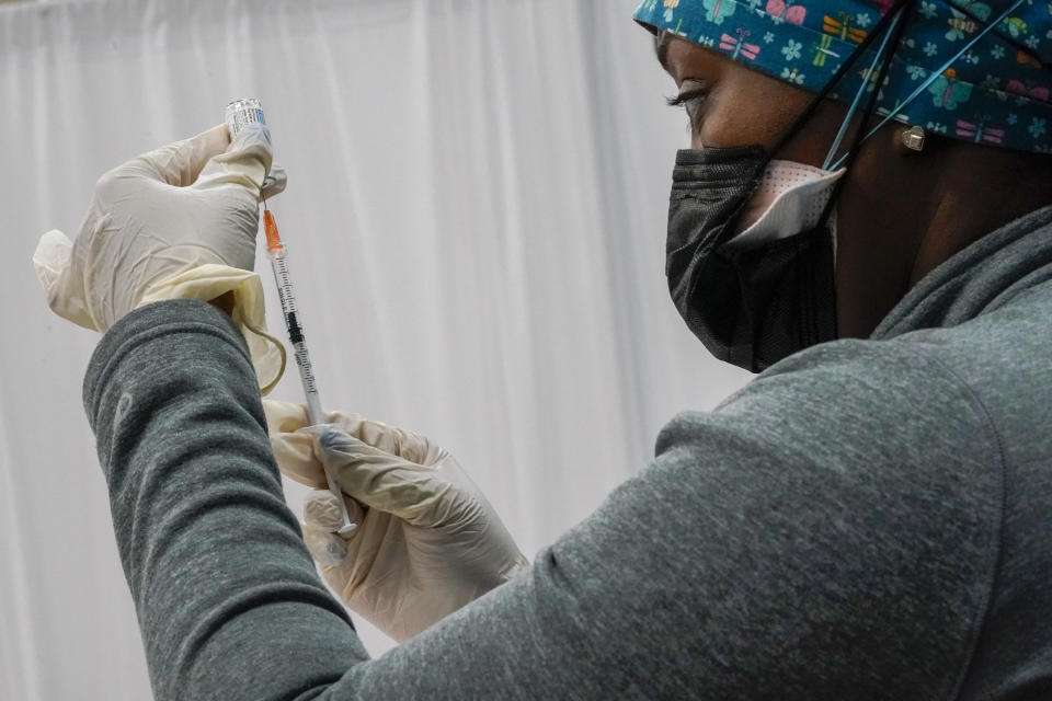 A Northwell Health registered nurse fills a syringe with the Johnson & Johnson COVID-19 vaccine at a pop up vaccination site inside the Albanian Islamic Cultural Center, Thursday, April 8, 2021, in the Staten Island borough of New York. Ahead of Ramadan, Islamic leaders are using social media, virtual town halls and face-to-face discussions to spread the word that it’s acceptable for Muslims to be vaccinated during daily fasting that happens during the holy month. (AP Photo/Mary Altaffer)