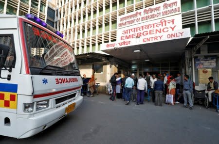 An ambulance arrives as people stand at the entrance of the emergency department of a government-run hospital in New Delhi, India, November 22, 2017.   Picture taken November 22, 2017.  REUTERS/Saumya Khandelwal