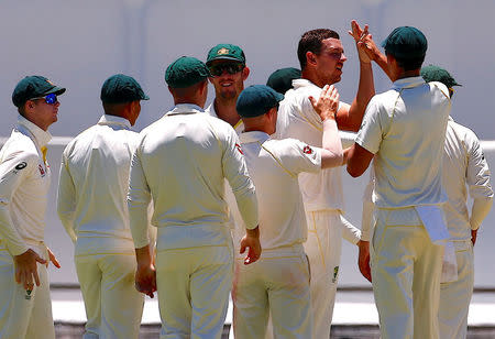 Cricket - Ashes test match - Australia v England - WACA Ground, Perth, Australia, December 14, 2017. Australia's Josh Hazlewood celebrates with team mates after dismissing England's James Vince during the first day of the third Ashes cricket test match. REUTERS/David Gray