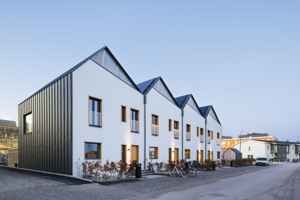 Side view of Street Monkey Architects' New Solar-Powered Prefab Row Houses in Sweden.