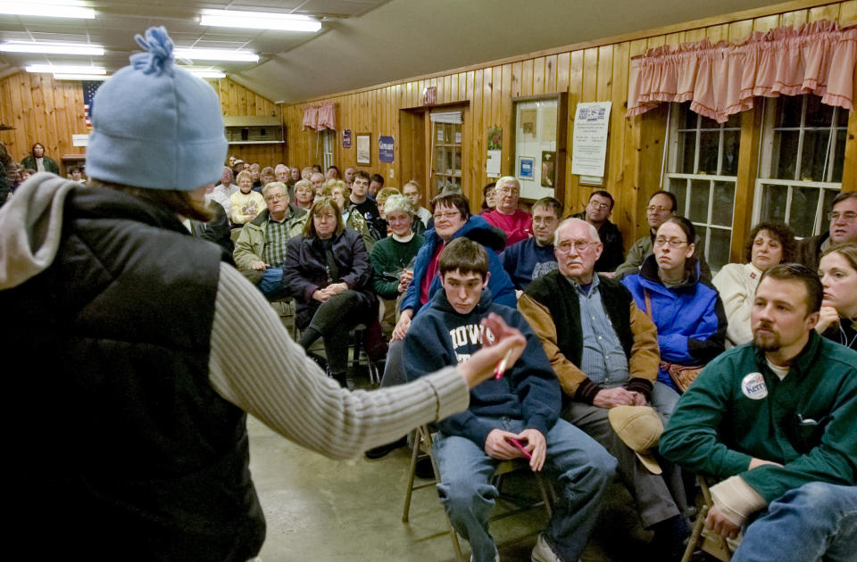 FILE - Iowa Democrats gather to choose their candidate for the 2004 presidential election at a caucus meeting in Slater, Iowa, Jan. 19, 2004. (AP Photo/Nati Harnik, File)