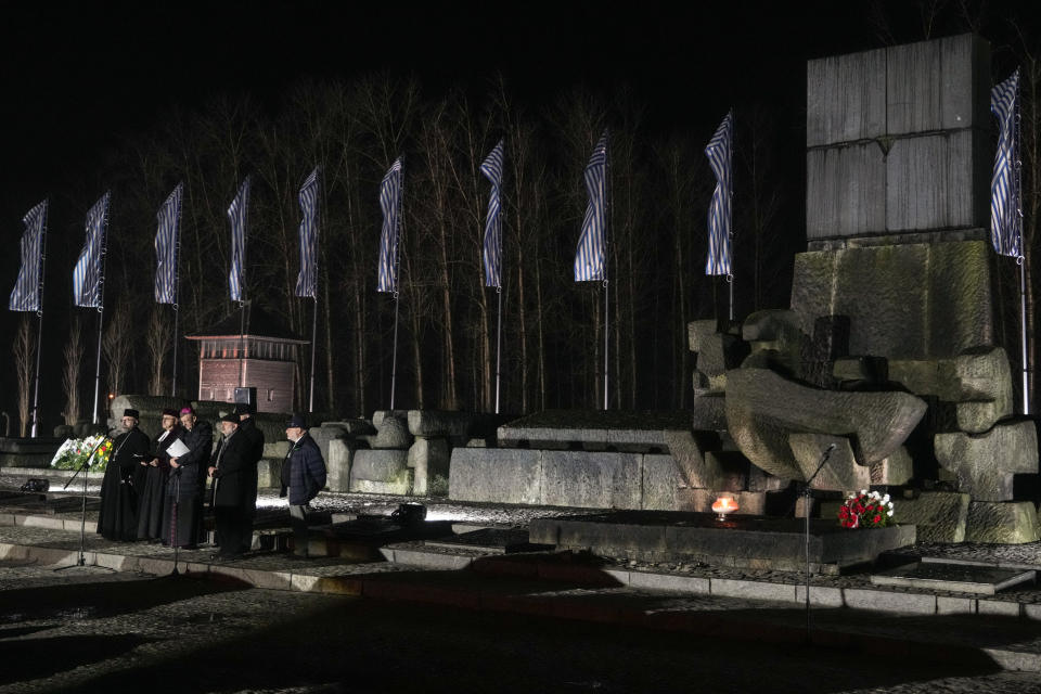 Clerics recite prayers by the monument at the Birkenau Nazi death camp during a ceremony in Oswiecim, Poland, Saturday, Jan. 27, 2024. Survivors of Nazi death camps marked the 79th anniversary of the liberation of the Auschwitz-Birkenau camp during World War II in a ceremony in southern Poland.(AP Photo/Czarek Sokolowski)