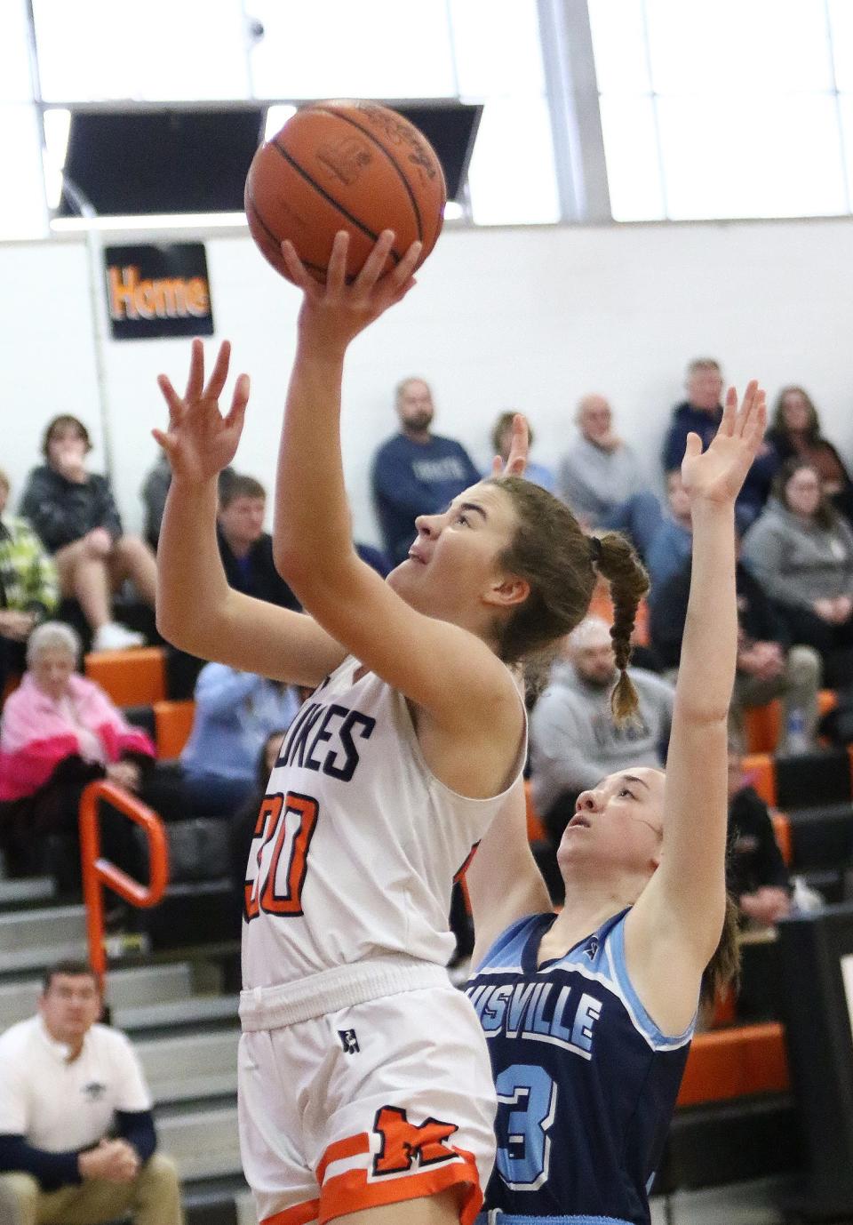 Marlington's Elizabeth Mason puts up a shot defended by Louisville's Taylor McCully during action Saturday afternoon at Marlington High School, January 28, 2023.