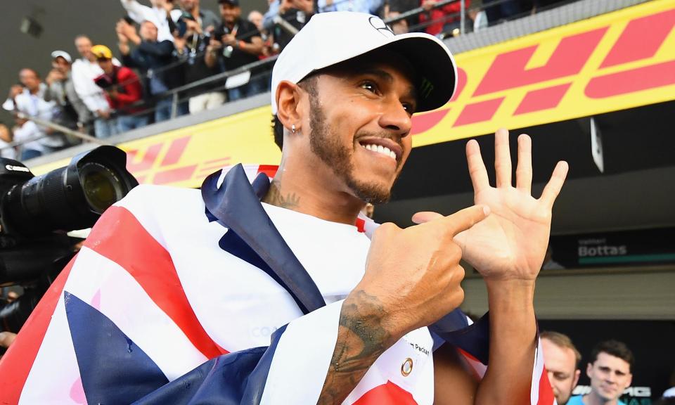 Lewis Hamilton opens his palm to show how many world titles he has now won.