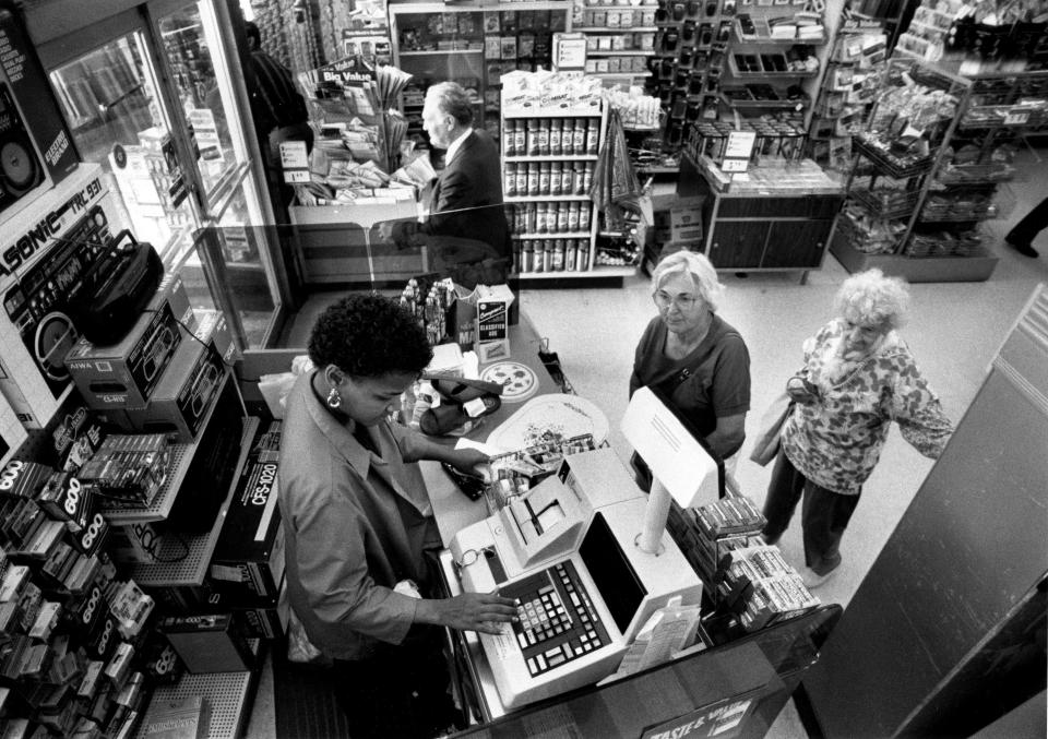 Pam Sephes works the checkout counter at Woolworth's in West Palm Beach in April 1992.