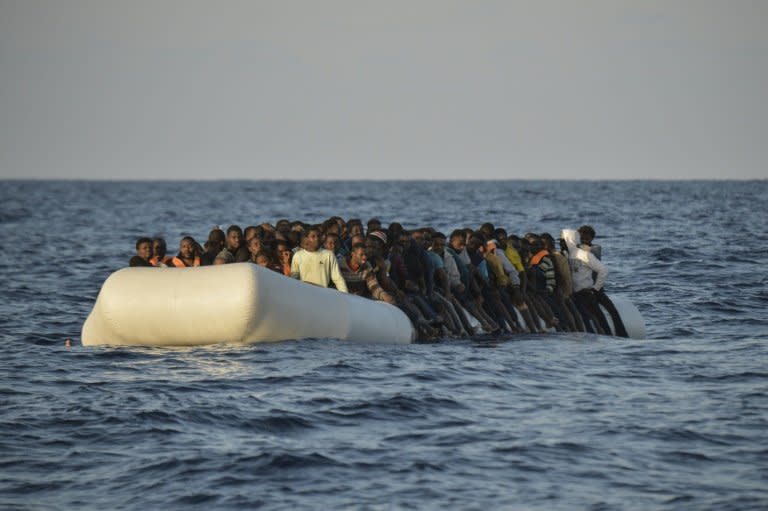 Migrants drift on a rubber boat shortly before being rescued off the Libyan coast in the  Mediterranean Sea, in November 2016