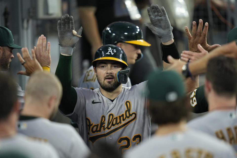 Oakland Athletics' Shea Langeliers (23) celebrates in the dugout after hitting a home run during the third inning of a baseball game against the Los Angeles Dodgers in Los Angeles, Wednesday, Aug. 2, 2023. (AP Photo/Ashley Landis)