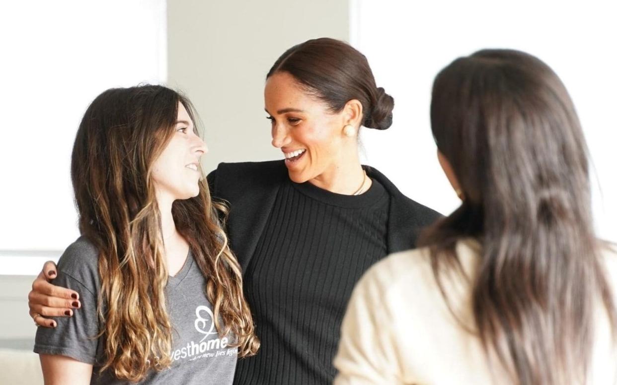 Meghan Markle was seen hugging a woman during the appearance - Harvest Home