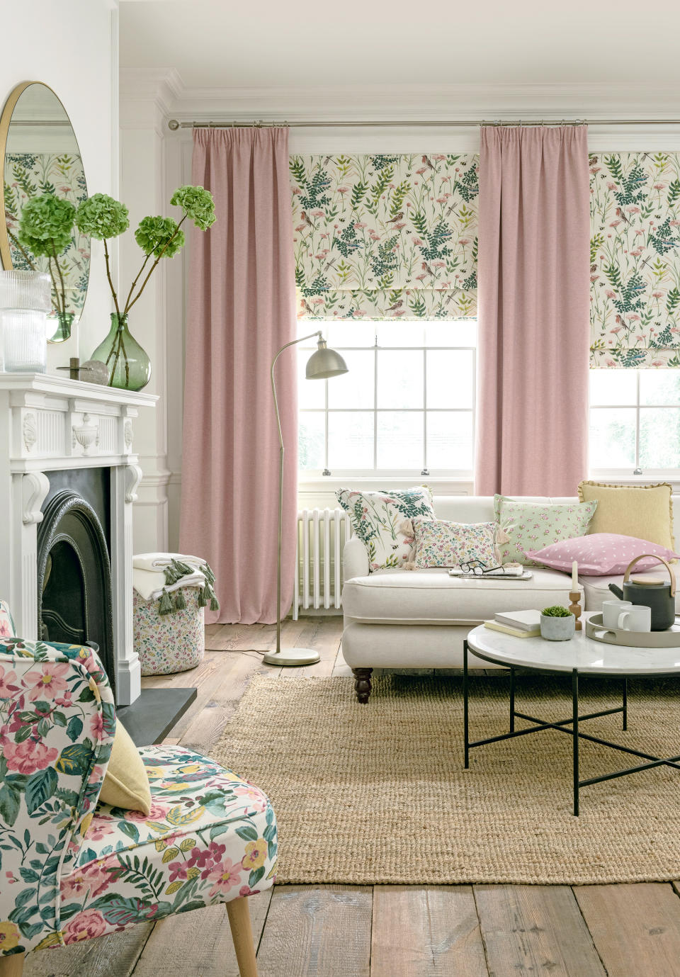 <p> For a relaxed and balanced living space, use plain blush pink curtains as a canvas to offset botanical prints and enhance the sense of light in the space. </p> <p> In this scheme by Clarke & Clarke, sash windows lend themselves to an elegant combination of Roman blinds in Gardenia in Blush, and sumptuous full-length curtains in Kelso in Blush. </p> <p> An accent chair and mix-and-match cushions tie the scheme together.    </p>