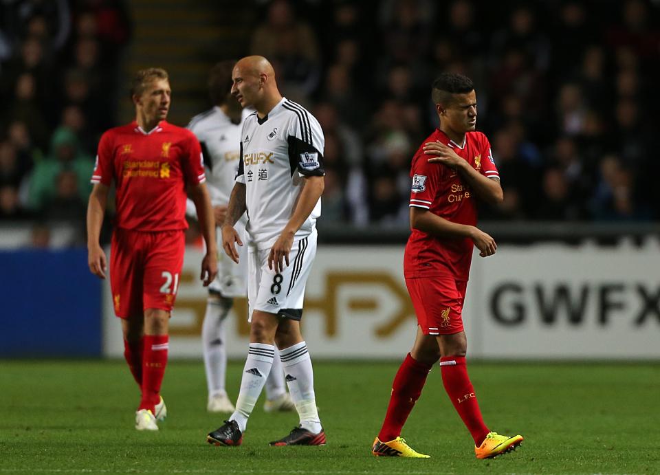 Liverpool's Phillippe Coutinho (right) leaves the field after picking up an injury