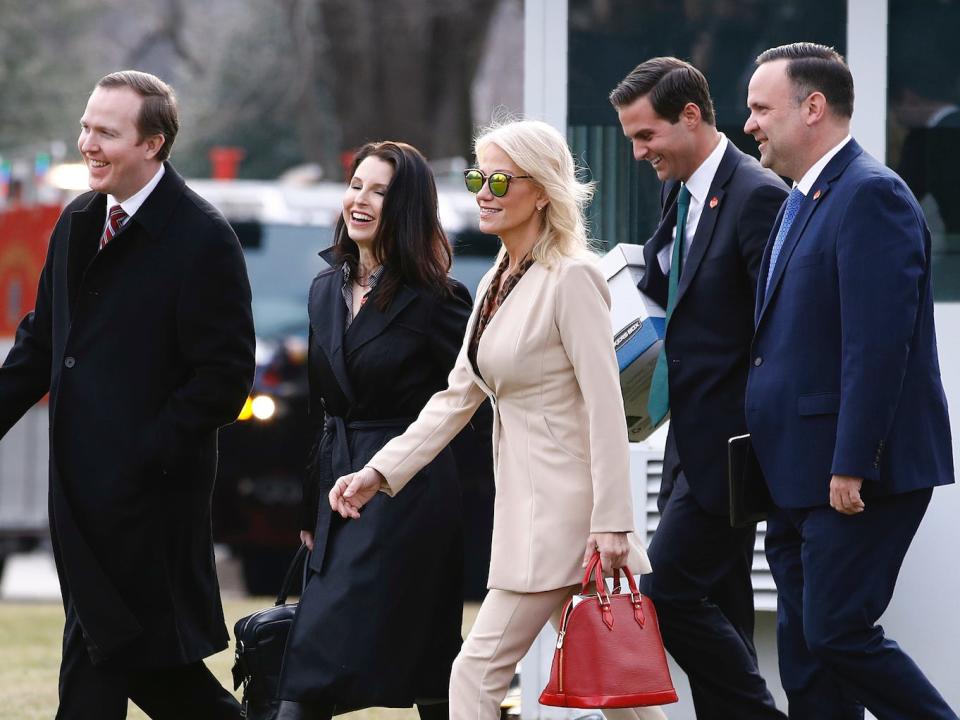 Political Director Brian Jack, Deputy Staff Secretery Catherine Keller, Counselor to the President Kellyanne Conway, aide John McEntee and White House Social Media Director Dan Scavino walk across the South Lawn of the White House in Washington, Thursday, Jan. 23, 2020.
