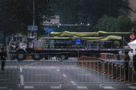 In this Saturday, Sept. 21, 2019, photo, a Chinese military vehicle possibly carrying a drone passes along the Jianguomenwai Avenue during a rehearsal for the 70th anniversary of Communist China, in Beijing. A parade on Tuesday, Oct. 1 by China’s secretive military will offer a rare look at its rapidly developing arsenal, including possibly a nuclear-armed missile that could reach the United States in 30 minutes, as Beijing gets closer to matching Washington and other powers in weapons technology. (AP Photo/Andy Wong)