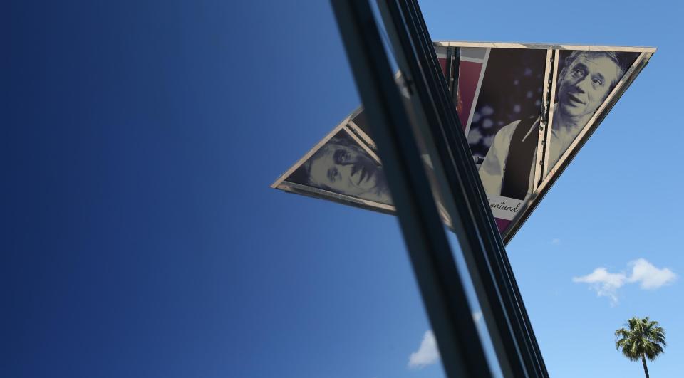 A reflection of French actor Yves Montand in the window of the Palais at the 67th international film festival, Cannes, southern France, Tuesday, May 13, 2014. (AP Photo/Alastair Grant)