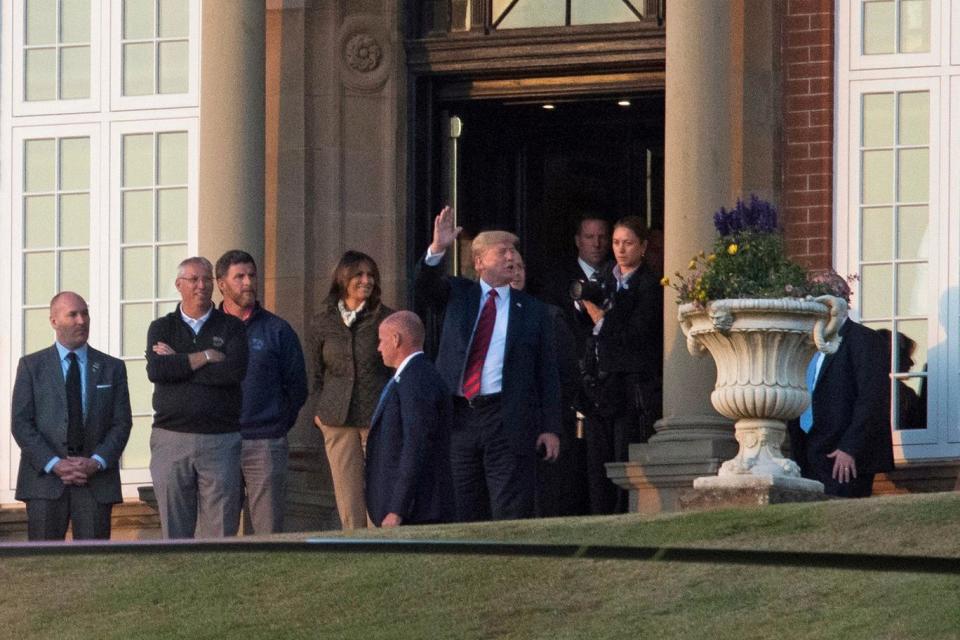 Donald and Melania Trump arrive at the Turnberry resort (PA)