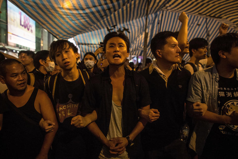 Pro-democracy activists join together to protect their protest tent from local residents and pro-government supporters on October 3, 2014 in Mong Kok, Hong Kong.   (Photo by Chris McGrath/Getty Images)