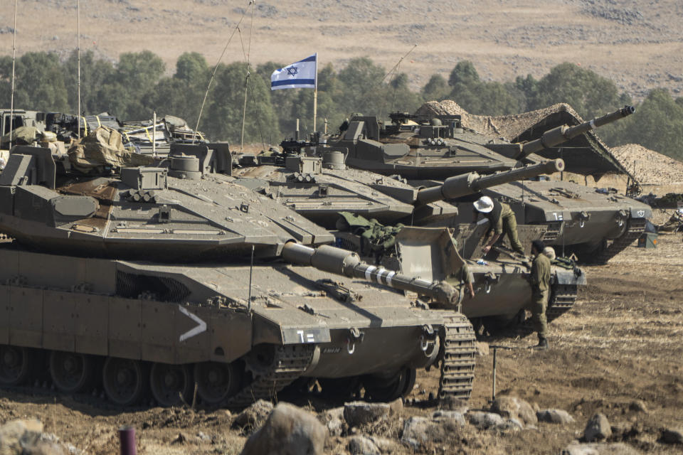 Israeli tanks are stationed near the border with Lebanon, in Israel, Saturday Oct. 14, 2023. (AP Photo/Petros Giannakouris)