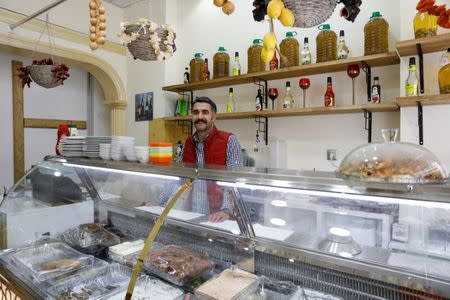 Restaurant owner Haluk Ozakin, 32, who says he will vote 'No' in the referendum, poses in his business in Diyarbakir, Turkey, April 6, 2017. REUTERS/Umit Bektas