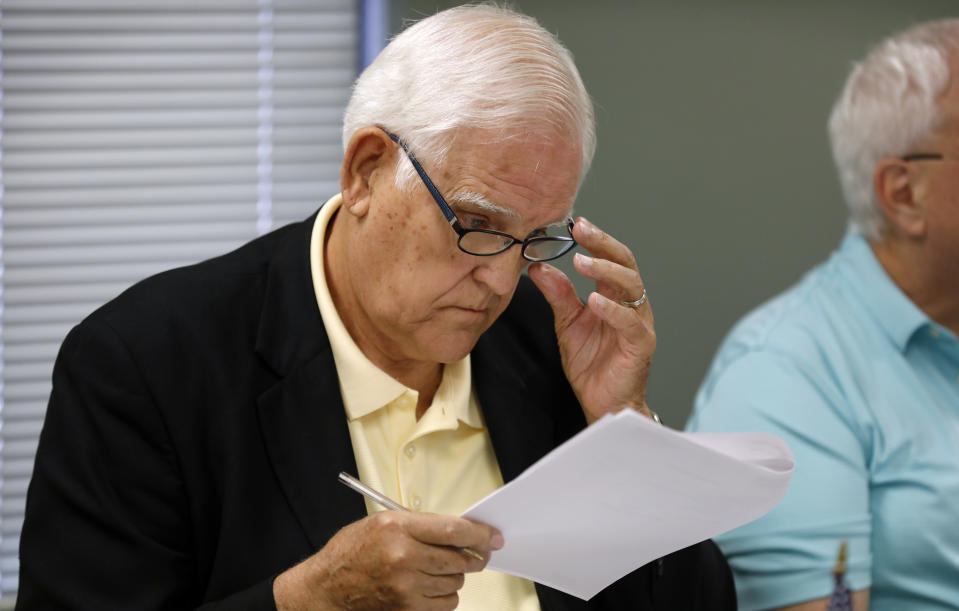Board of County Commissioners chairman Ed Eilert looks over the agenda during the Johnson County Board of Canvassers meeting, Monday, Aug. 13, 2018, in Olathe, Kan. County election officials across Kansas on Monday began deciding which provisional ballots from last week's primary election will count toward the final official vote totals, with possibility that they could create a new leader in the hotly contested Republican race for governor. Secretary of State Kris Kobach led Gov. Jeff Colyer by a mere 110 votes out of more than 313,000 cast as of Friday evening. (AP Photo/Charlie Neibergall)