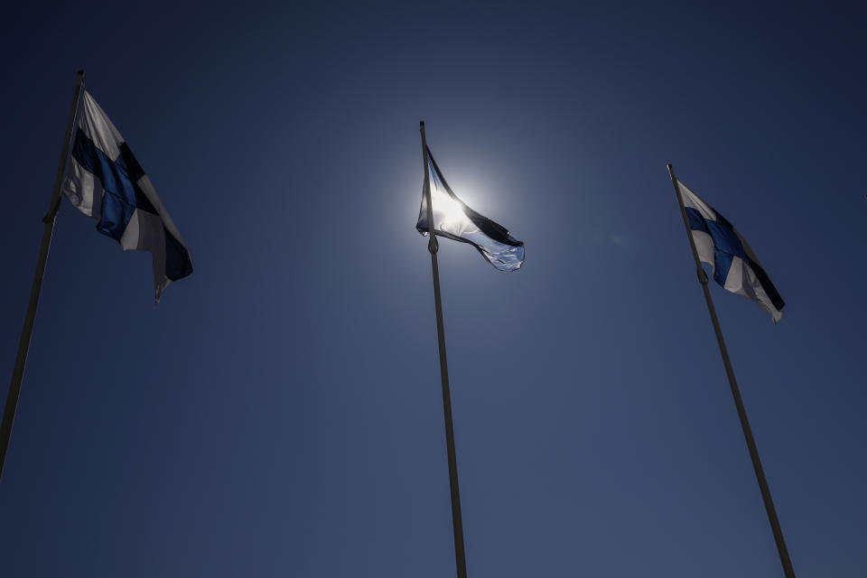 NATO and Finland flags flutter over the building of Ministry of Foreign Affairs in Helsinki, Finland, Tuesday, April 4, 2023. Finland prepared to make its historic entry into NATO Tuesday, a step that doubles the Western alliance’s border with Russia and ends decades of non-alignment for the Nordic nation. (AP Photo/Sergei Grits)