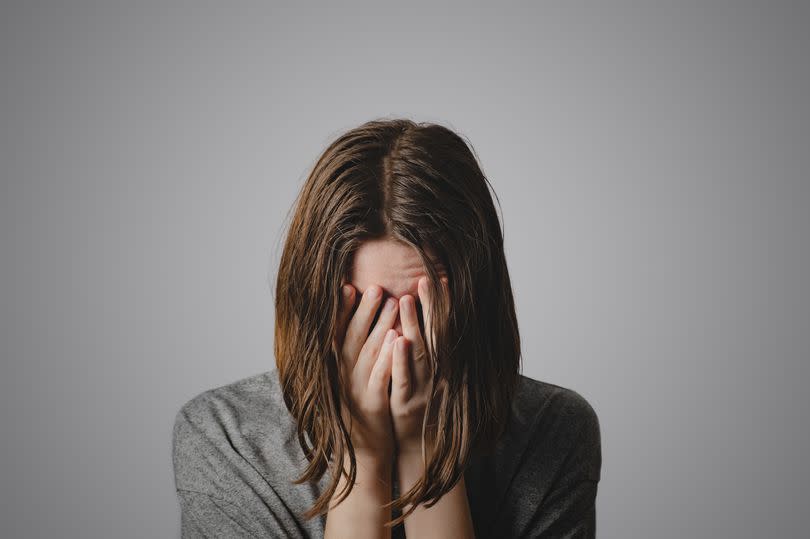 A stock image of a woman dealing with mental health issues