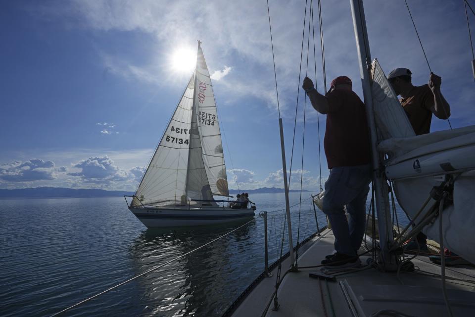 People sail on the Great Salt Lake on June 14, 2023, near Magna, Utah. Sailors back out on the water are rejoicing after a snowy winter provided temporary reprieve. (AP Photo/Rick Bowmer)