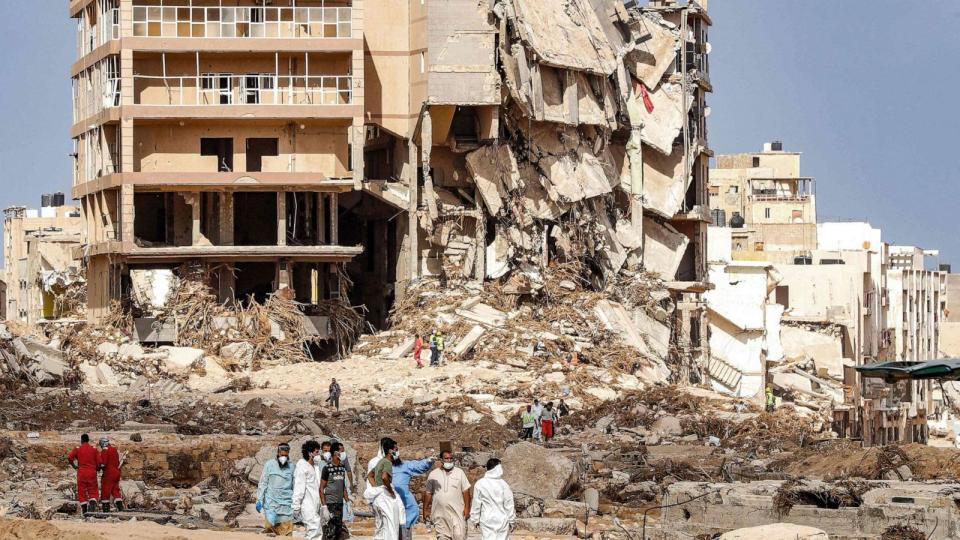 PHOTO: Rescue teams walk in a flood-ravaged area of Derna, eastern Libya, on Sept. 18, 2023. (Mahmud Turkia/AFP via Getty Images)