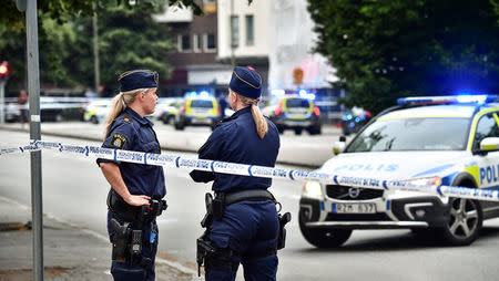 Police stand next to a cordon after a shooting on a street in central Malmo, Sweden June 18, 2018. TT News Agency/Johan Nilsson/via REUTERS