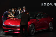 Attendees look at Honda GT during Auto China 2024 in Beijing, Thursday, April 25, 2024. Global automakers and EV startups unveiled new models and concept cars at China's largest auto show on Thursday, with a focus on the nation's transformation into a major market and production base for digitally connected, new-energy vehicles. (AP Photo/Ng Han Guan)