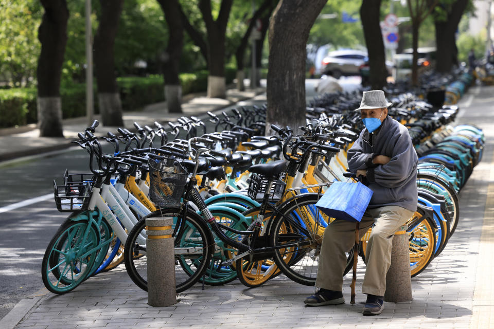 An elderly Chinese man waits for his meal to be delivered in Beijing Tuesday, May 11, 2021. The number of working-age people in China fell over the past decade as its aging population barely grew, a census showed Tuesday, adding to economic challenges for Chinese leaders who have ambitious strategic goals. (AP Photo/Ng Han Guan)