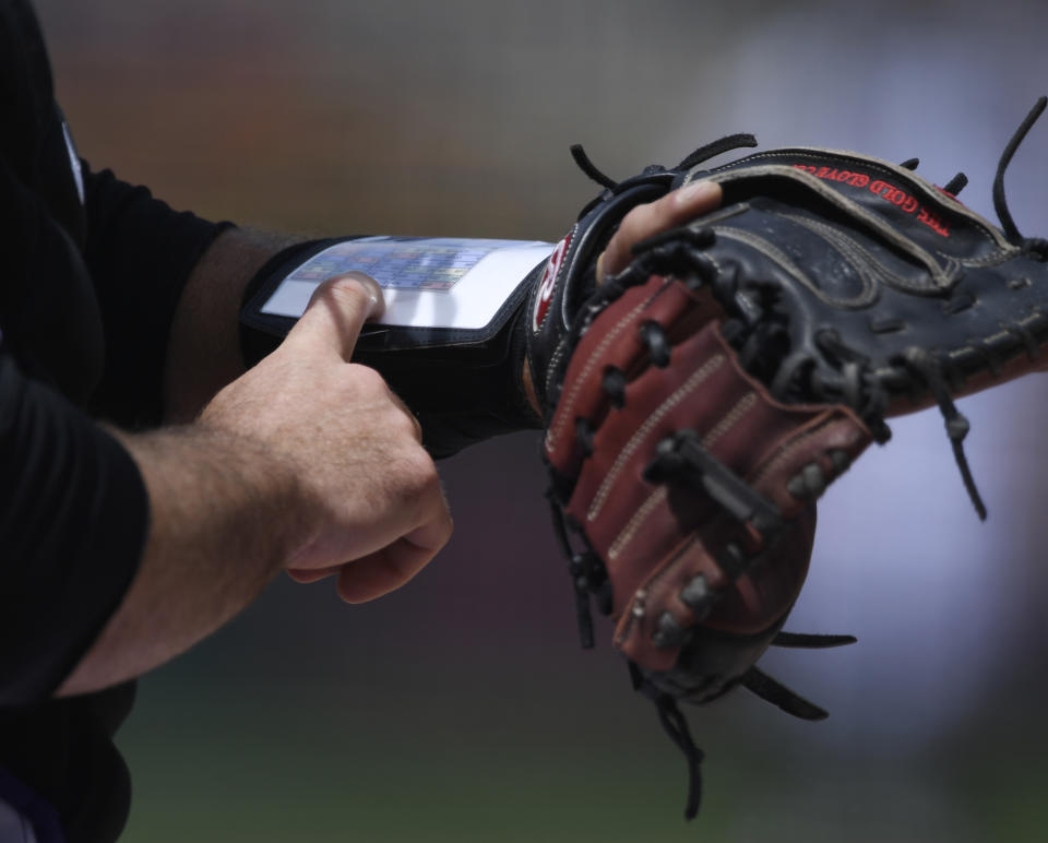 DENVER, CO - MAY 09: Colorado Rockies catcher Chris Iannetta #22 checks his wrist band for guidance in the first inning against the Los Angeles Angels at Coors Field May 09, 2018. (Photo by Andy Cross/The Denver Post via Getty Images)
