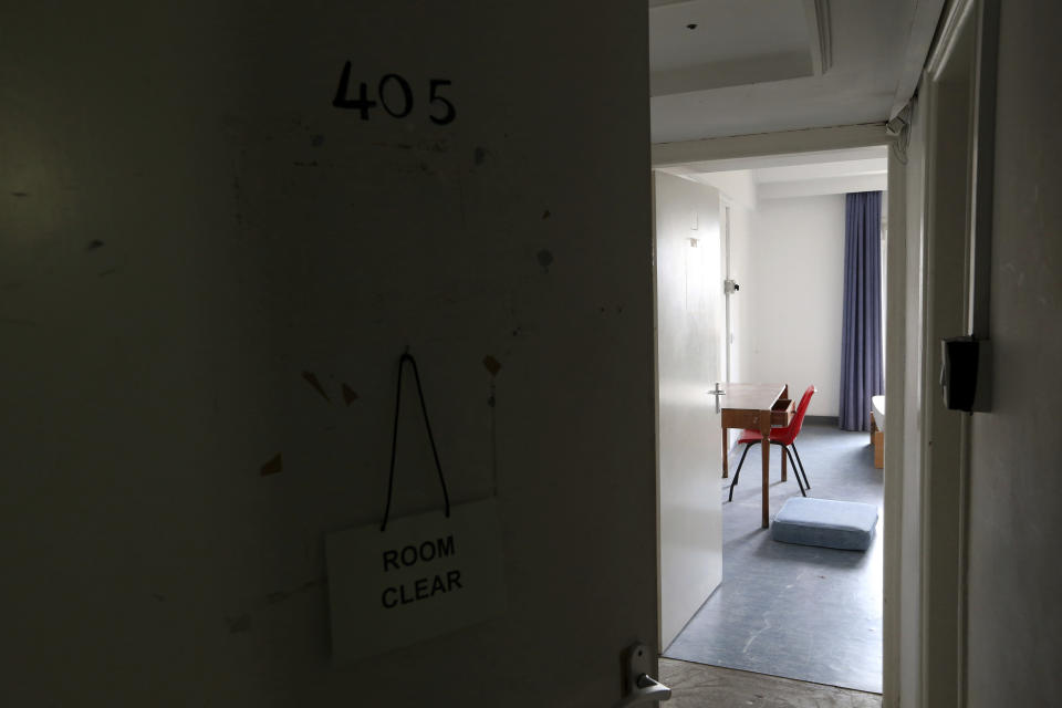 In this Friday, April 19, 2019 photo, a chair and a table sit in an empty room at the Ledra Palace hotel inside the U.N buffer zone in the divided capital Nicosia, Cyprus. This grand hotel still manages to hold onto a flicker of its old majesty despite the mortal shell craters and bullet holes scarring its sandstone facade. Amid war in the summer of 1974 that cleaved Cyprus along ethnic lines, United Nations peacekeepers took over the Ledra Palace Hotel and instantly turned it into an emblem of the east Mediterranean island nation's division. (AP Photo/Petros Karadjias)