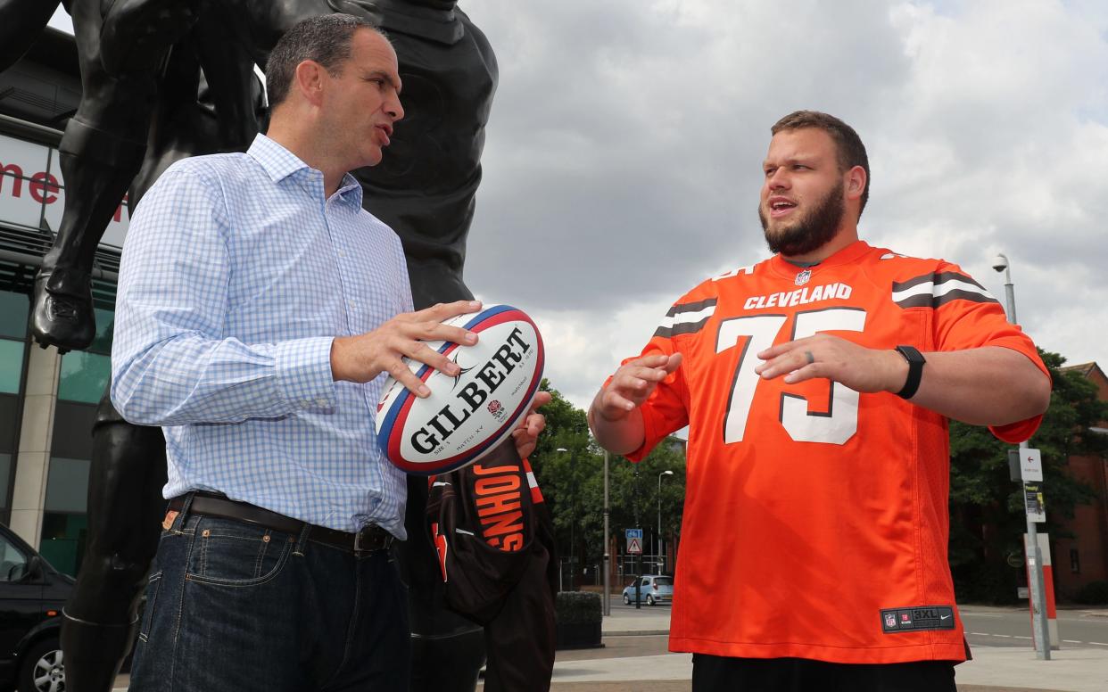 Johnson shares some sporting knowledge with the Clevelan Browns' Joel Bitonio - © Sean Ryan/ NFL