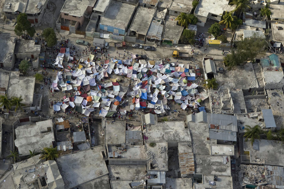 <p>Makeshift tents are seen after an earthquake on Jan. 13, 2010 in Port-au-Prince, Haiti. (Photo: Logan Abassi/MINUSTAH via Getty Images) </p>