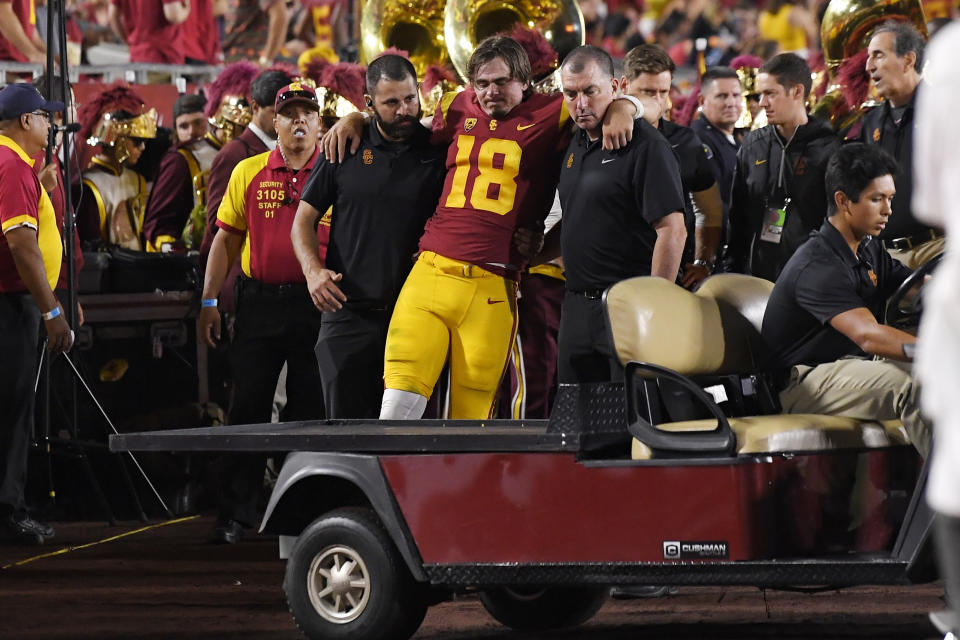 Southern California quarterback JT Daniels is helped to a cart after being injured during the first half of an NCAA college football game against Fresno State Saturday, Aug. 31, 2019, in Los Angeles. (AP Photo/Mark J. Terrill)