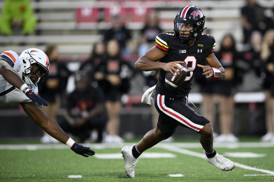 Maryland quarterback Taulia Tagovailoa (3) is chased by Virginia defensive end Paul Akere (1) during the first half of an NCAA college football game, Friday, Sept. 15, 2023, in College Park, Md. (AP Photo/Nick Wass)