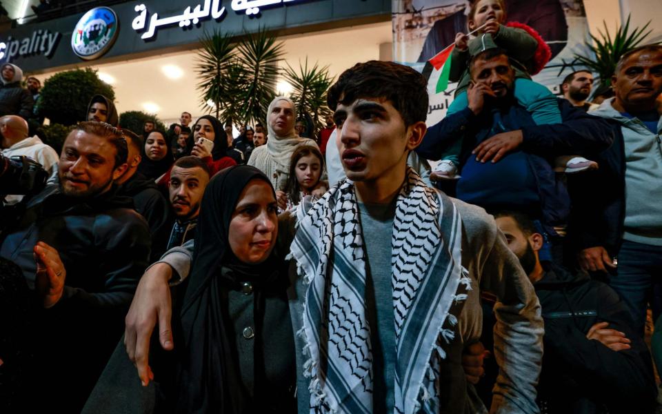 A Palestinian prisoner (R) hugs a relative after detainees were released from Israeli jails in exchange for hostages released by Hamas from the Gaza Strip, upon they arrival in Ramallah in the occupied West Bank early on November 26, 2023. Hamas on November 25, released a second group of Israeli and foreign civilians it had been holding hostage in the Gaza Strip in exchange for Palestinian prisoners, after an hours-long unexpected delay set nerves on edge. Israeli authorities said 13 Israelis and four Thai citizens had returned to Israel. (Photo by Jaafar ASHTIYEH / AFP) (Photo by JAAFAR ASHTIYEH/AFP via Getty Images)