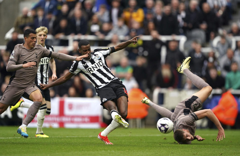 Newcastle United's Alexander Isak, centre, scores the opening goal during the English Premier League soccer match between Newcastle United and Tottenham Hotspur at St. James' Park in Newcastle, England, Saturday, April 13, 2024. (Owen Humphreys/PA via AP)