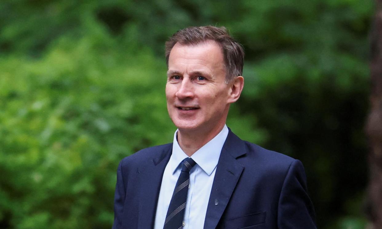 <span>Jeremy Hunt was accused by Labour of seeking to implement ‘dangerous Trussonomics’ by stealth.</span><span>Photograph: Hollie Adams/Reuters</span>