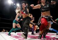 Wrestler Kris Wolf (C) and fellow wrestlers scatter across the ring during their Stardom female professional wrestling show at Shinkiba 1st Ring in Tokyo, Japan, December 6, 2015. REUTERS/Thomas Peter