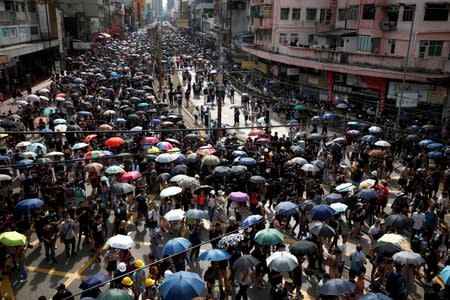 Demonstrators march to protest against the Yuen Long attacks in Yuen Long