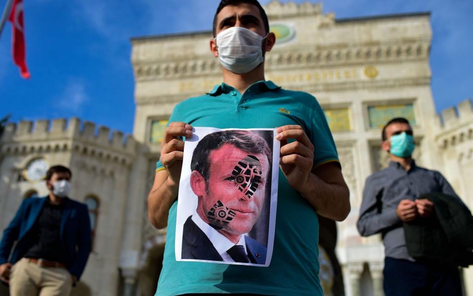 President Macron's decision to defend the showing of drawings of the Prophet Muhammad caused outrage across the Muslim world - YASIN AKGUL /AFP