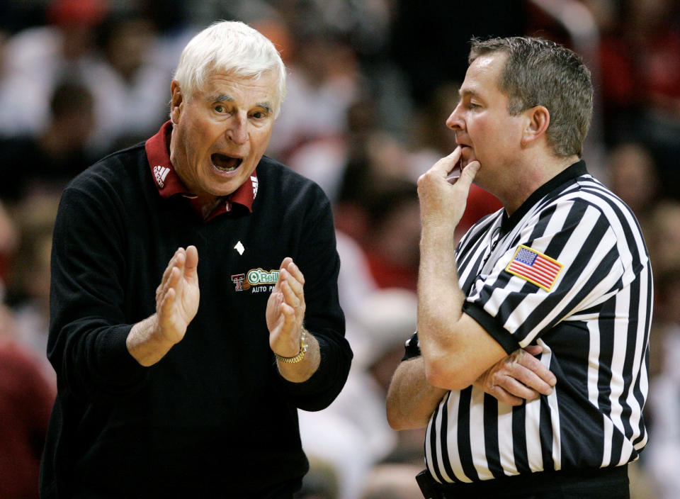 FILE - Texas Tech coach Bob Knight, left, argues a call with an NCAA official during a basketball game against Texas A&M in Lubbock, Texas, Wednesday, Jan. 16, 2008. Knight earned his 900th career win in the 68-53 win over Texas A&M. Bob Knight, the brilliant and combustible coach who won three NCAA titles at Indiana and for years was the scowling face of college basketball has died. He was 83. Knight's family made the announcement on social media Wednesday evening, Nov. 1, 2023. (AP Photo/Tony Gutierrez, File)