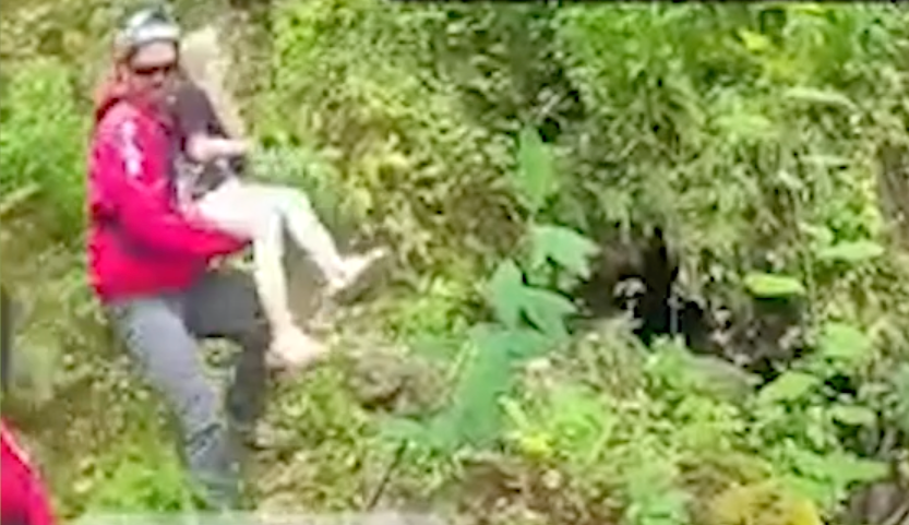 A first responder lifts the girl onto a boat.